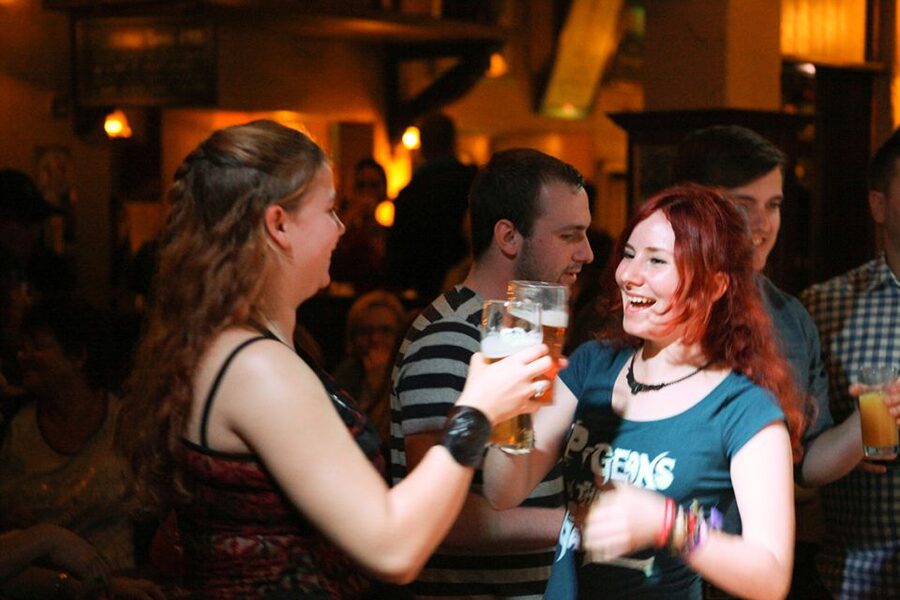 Pints being handed across a crowded Dublin bar
